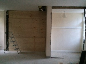 The dividing wall to the stables had just been removed but it's boarded up until the new kitchen doors and windows are in. The vestibule and weird office door are both being transformed too.